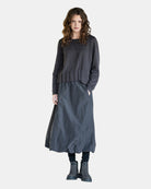 Model wearing LEEZZA AMBER & MOON DEMI long balloon skirt in charcoal taffeta with a wide jersey waistband